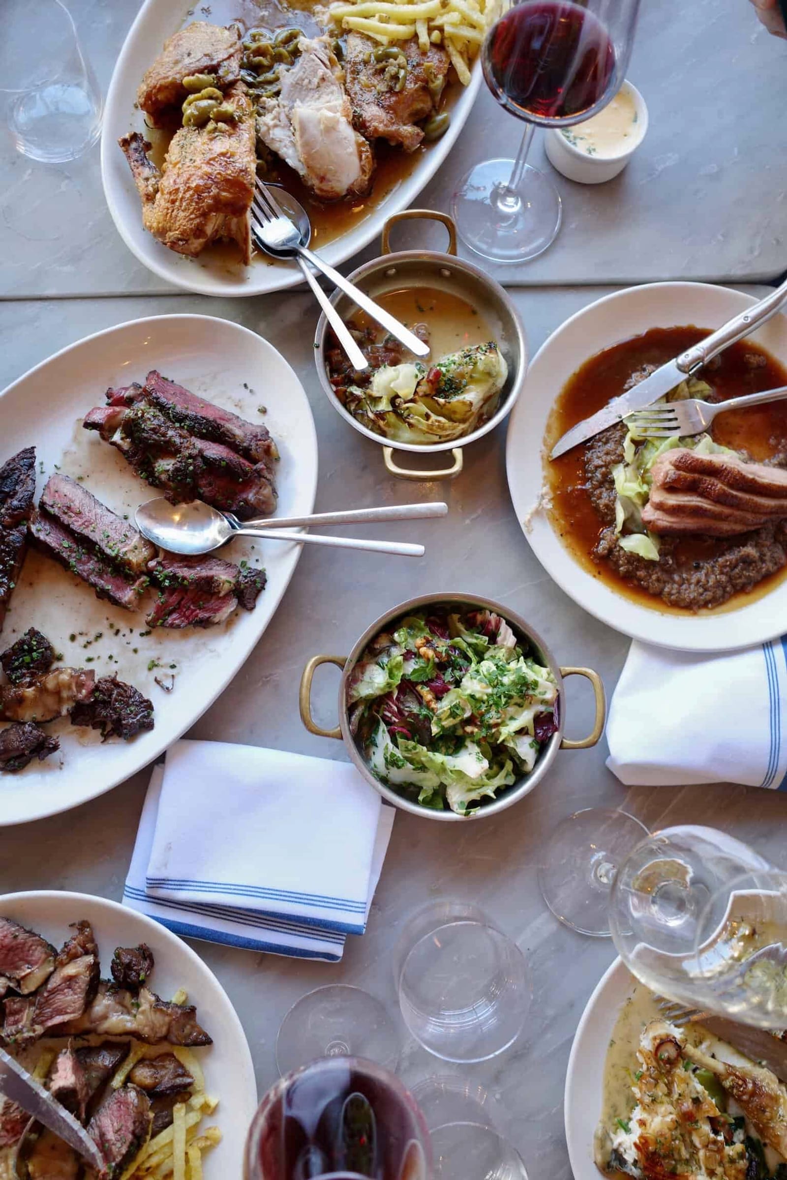 A feast at littlefrench: dishes on the marble table, from above