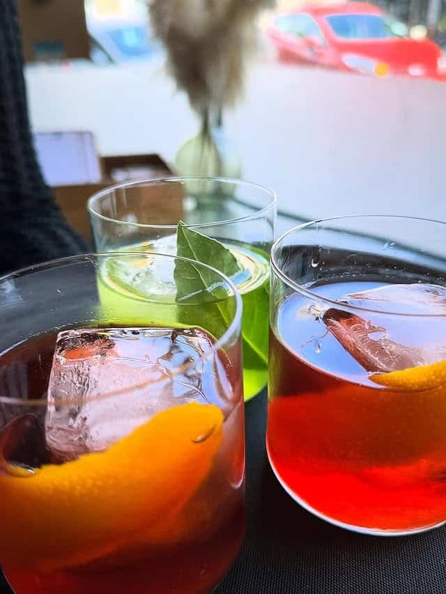 Cocktails at the bar, a negroni among them