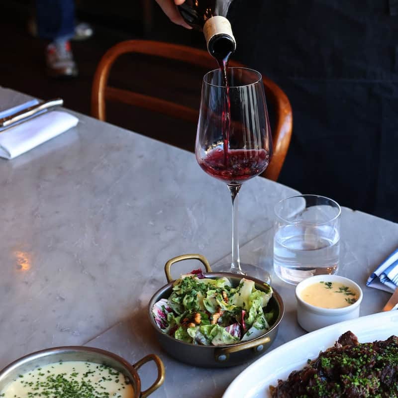 Red wine poured at the marble table